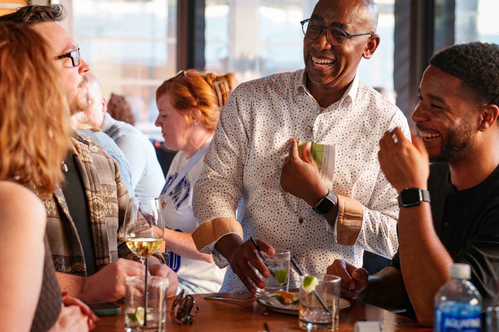 Candid moment around a table at a corporate event photographed by Kurt Nelson