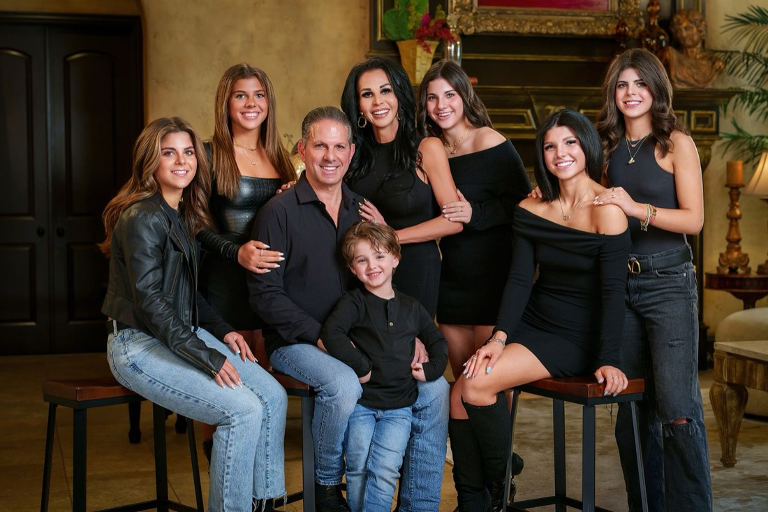 Multi generation family portrait photographed in a warm interior