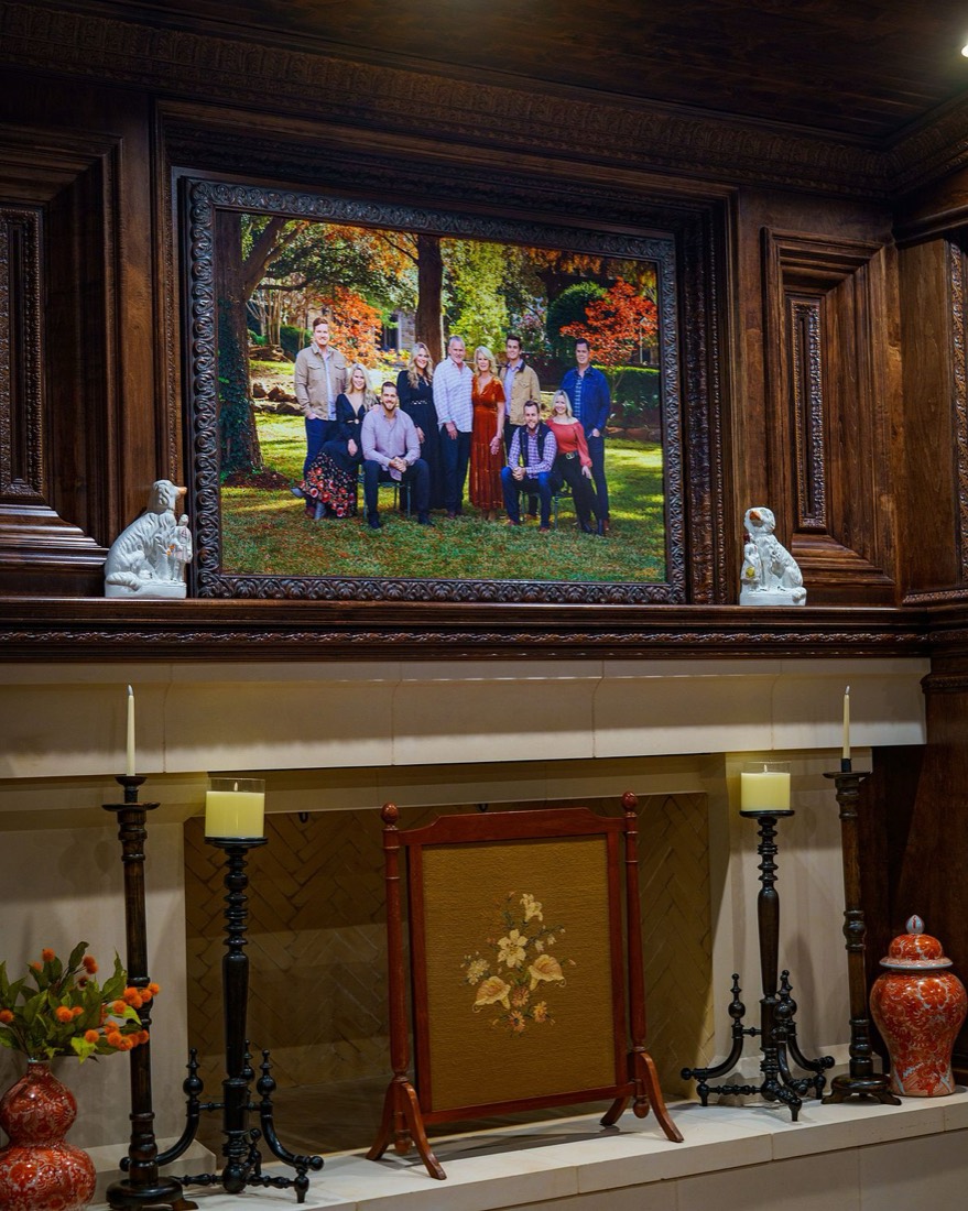 Framed family portrait displayed in a paneled living room