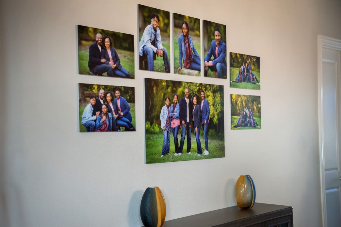 Family portrait collection displayed as canvas prints on a hallway wall