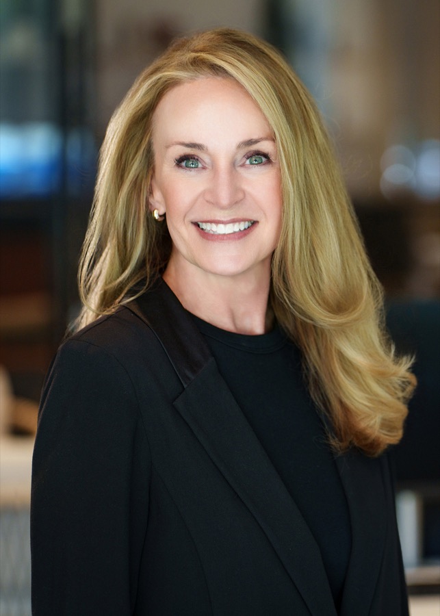Studio headshot of a businesswoman in a black blazer