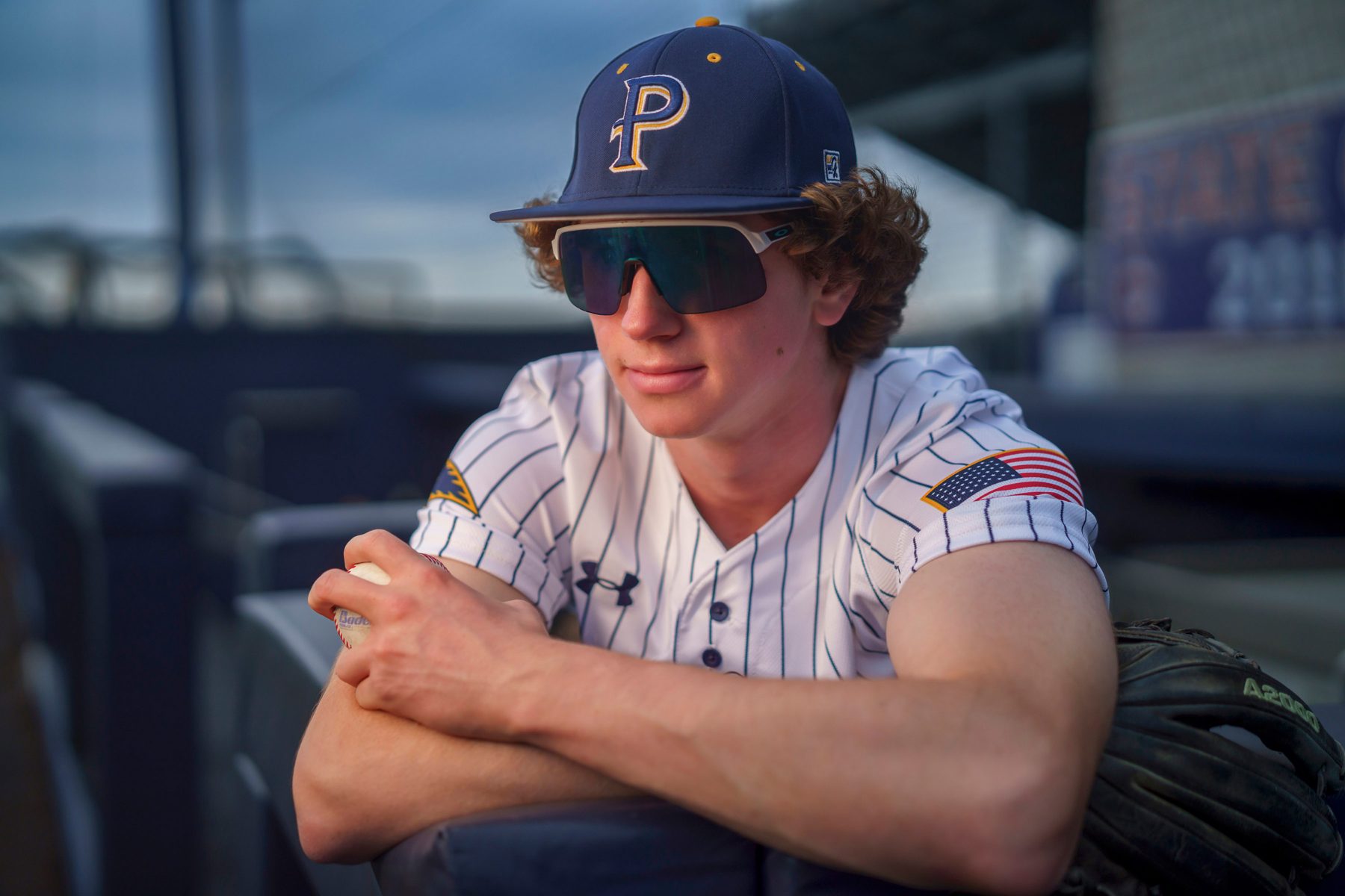 Senior baseball player in the dugout